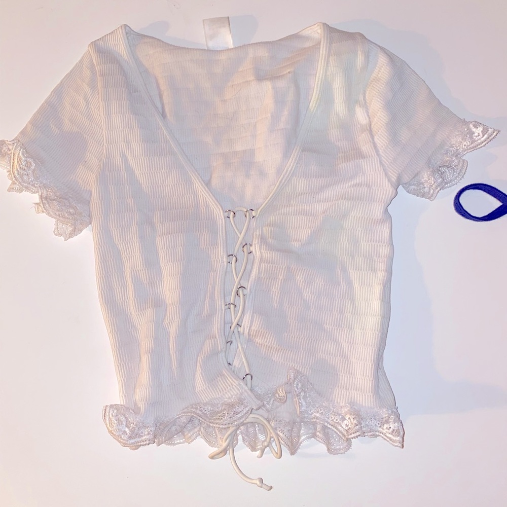 White top with crisscrossing string in the front